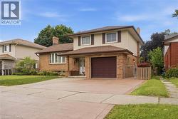 Brick and siding exterior with a two-car driveway and attached garage - 