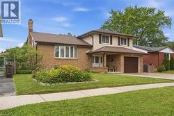Brick and siding exterior featuring a covered front entry - 
