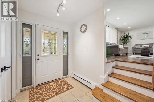 Entryway featuring a decorative glass front door with sidelights, ceramic tile flooring, and track lighting - 76 Lower Canada Crescent, Kitchener, ON - Indoor Photo Showing Other Room