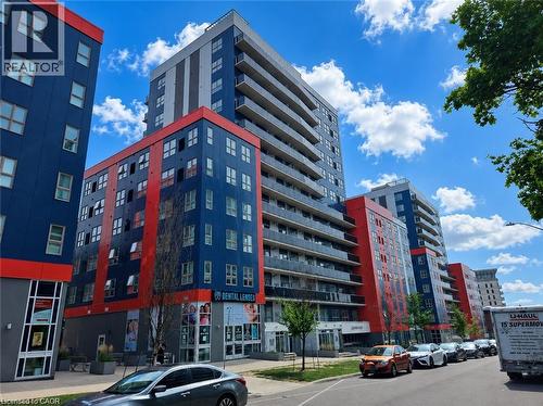 Modern high-rise residential building featuring a vibrant blue and red facade with gray accents - 258B Sunview Street Unit# 255, Waterloo, ON - Outdoor With Facade