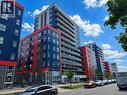 Modern high-rise residential building featuring a vibrant blue and red facade with gray accents - 258B Sunview Street Unit# 255, Waterloo, ON  - Outdoor With Facade 