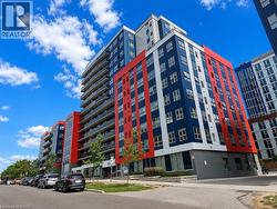 Modern high-rise building featuring a striking red, blue, and white facade - 