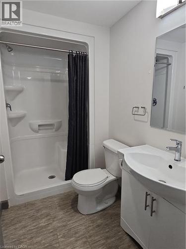 Full bath with vanity, a shower with curtain, and wood finished floors - 258B Sunview Street Unit# 255, Waterloo, ON - Indoor Photo Showing Bathroom