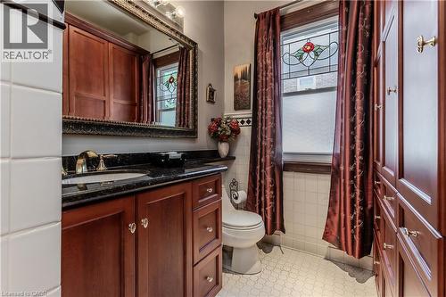 Cherry wood-finish cabinetry and built-in storage - 569 Locust Street, Burlington, ON - Indoor Photo Showing Bathroom