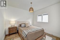 Bright interior room with wood-finish flooring and white baseboards - 