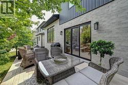 Expansive outdoor deck with composite decking and a decorative area rug - 