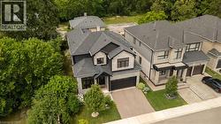 Modern residential property featuring a stone and dark siding exterior - 