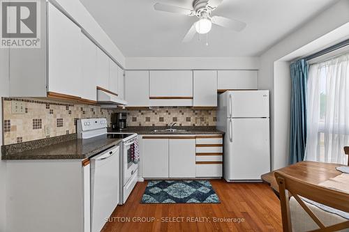 Kitchen with Hardwood Floor - 24 - 75 Ansondale Road, London South (South Q), ON - Indoor Photo Showing Kitchen With Double Sink