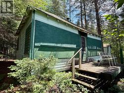 Lakeside of cottage with shutters on - 