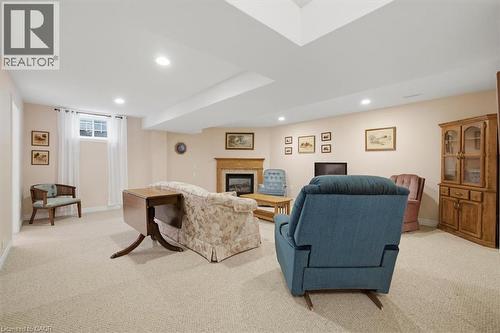 Carpeted living space featuring recessed lighting and a window with white curtains - 34 Southbrook Drive Unit# 13, Binbrook, ON - Indoor Photo Showing Basement