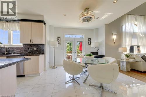 Open-concept living space with white marble-look tile flooring - 2380 Woodcrest Drive, Oakville, ON - Indoor