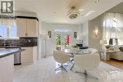 Open-concept living space with white marble-look tile flooring - 