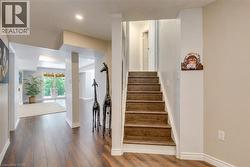 Hardwood-finish flooring throughout the hallway and open-concept room - 