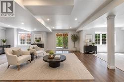 Spacious finished lower level featuring recessed lighting, wood-finish flooring, multiple windows, and a sliding glass door - 