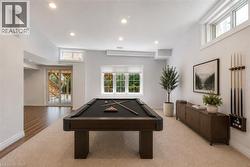 Recreation room featuring a dark wood pool table, recessed lighting, and a combination of carpet and wood-finish flooring - 