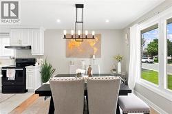 Open-concept dining area featuring a modern black linear chandelier - 