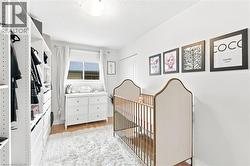 Hardwood flooring complemented by light-toned walls and a window offering natural illumination - 
