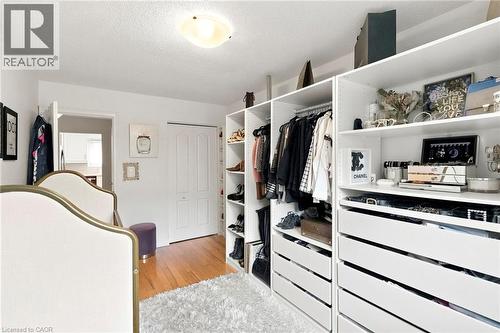 Custom closet organization system featuring white shelving and integrated drawers - 15 Quay Court, Hamilton, ON - Indoor With Storage