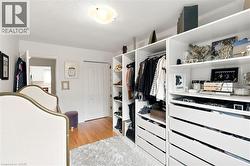 Custom closet organization system featuring white shelving and integrated drawers - 