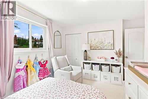 Bright room with a large window, plush carpet flooring, and white painted walls - 15 Quay Court, Hamilton, ON - Indoor Photo Showing Bedroom