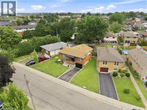 Brick facade residence with a pitched roof, featuring a single-car garage and an asphalt driveway - 15 Quay Court, Hamilton, ON - Outdoor With View