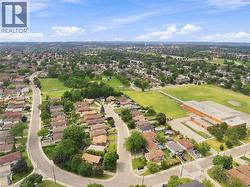 Aerial perspective of a residential neighborhood featuring numerous detached homes with established landscaping - 