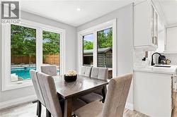 Bright dining area with light wood-finish flooring and recessed lighting - 