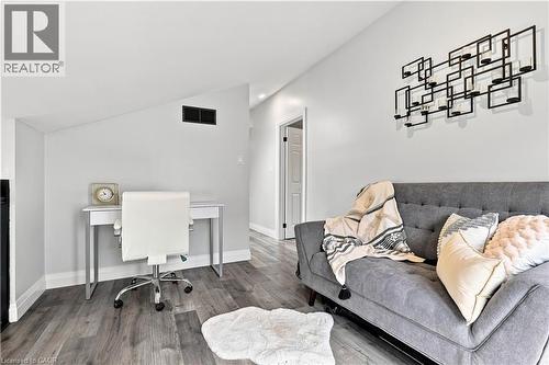 Interior space featuring wood-finish flooring, white baseboards, and a light gray wall color - 10 Rolling Acres Drive, Kitchener, ON - Indoor