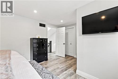 Light wood-finish flooring extending throughout, complemented by crisp white walls and baseboards - 10 Rolling Acres Drive, Kitchener, ON - Indoor Photo Showing Bedroom