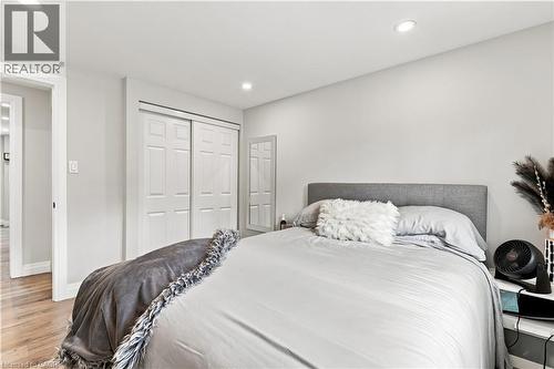 Room featuring recessed lighting, light-toned wall finishes, wood-finish flooring, and white bi-fold closet doors - 10 Rolling Acres Drive, Kitchener, ON - Indoor Photo Showing Bedroom