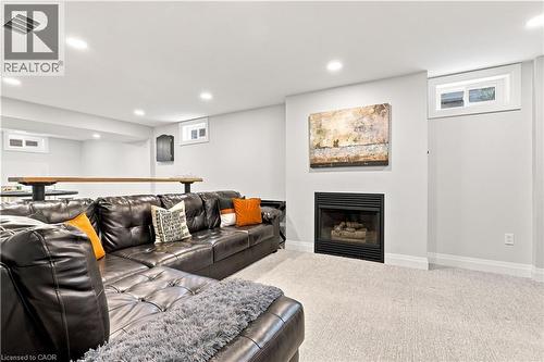 Carpeted living area featuring a built-in fireplace, recessed lighting, and a built-in bar - 10 Rolling Acres Drive, Kitchener, ON - Indoor With Fireplace