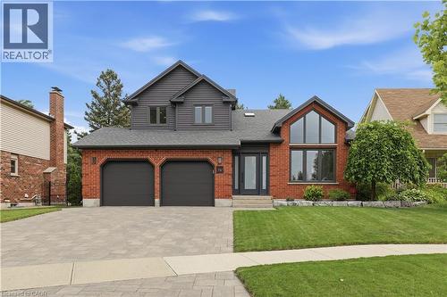 Brick and siding exterior featuring a prominent gabled entry with expansive windows - 10 Rolling Acres Drive, Kitchener, ON - Outdoor With Facade