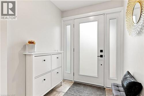 Entryway featuring a white door with frosted glass panels, black hardware, and coordinating frosted sidelites - 10 Rolling Acres Drive, Kitchener, ON - Indoor Photo Showing Other Room