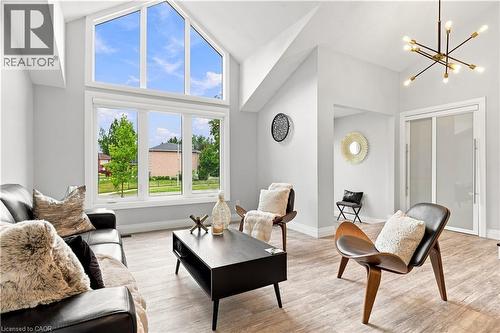 Vaulted ceilings with an expansive arched window feature and wood-finish flooring - 10 Rolling Acres Drive, Kitchener, ON - Indoor Photo Showing Living Room
