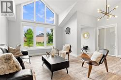 Vaulted ceilings with an expansive arched window feature and wood-finish flooring - 