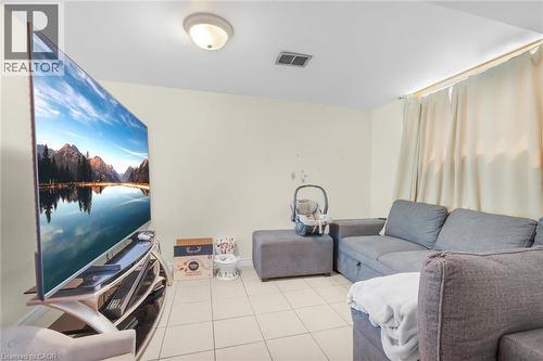 LOWER LEVEL BEDROOM CURRENTLY USED AS A LIVING ROOM/TV ROOM - 591 Mohawk Road W, Hamilton, ON - Indoor