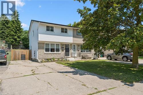 Two-story residence featuring light-colored siding and stone veneer accents - 589 Elgin Street N, Cambridge, ON - Outdoor