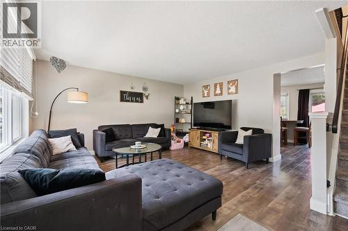 Spacious living area featuring wood-finish flooring, a neutral color palette, and an arched doorway - 589 Elgin Street N, Cambridge, ON - Indoor Photo Showing Living Room