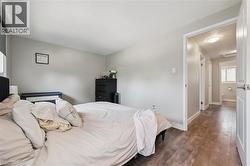 Room featuring wood-finish flooring and light gray wall paint - 