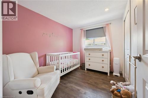 Versatile room featuring wood-finish flooring and a window with roller shade - 589 Elgin Street N, Cambridge, ON - Indoor Photo Showing Bedroom