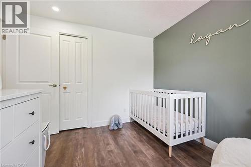 Neutral-toned room featuring wood-finish flooring, a white trim package, and recessed ceiling lighting - 589 Elgin Street N, Cambridge, ON - Indoor Photo Showing Bedroom