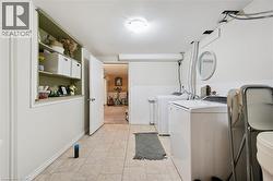 Laundry area featuring tile flooring and built-in shelving - 