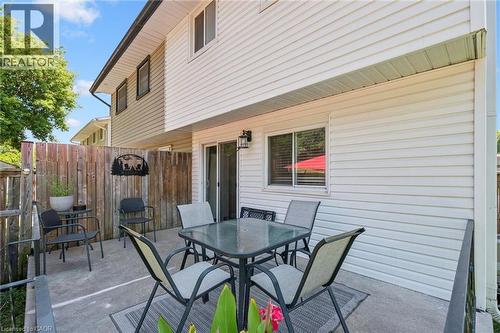 Private concrete patio with a wooden privacy fence - 589 Elgin Street N, Cambridge, ON - Outdoor With Deck Patio Veranda With Exterior