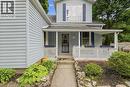 Light blue vinyl siding exterior with a covered front porch featuring white railings - 153 Montrose Street N, Cambridge, ON  - Outdoor With Deck Patio Veranda With Exterior 