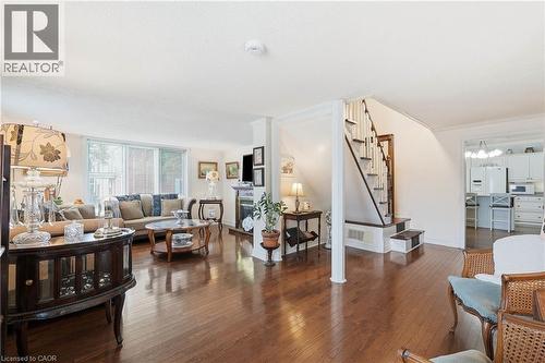 Spacious interior featuring wood-finish flooring, a contemporary fireplace, and large windows - 153 Montrose Street N, Cambridge, ON - Indoor Photo Showing Living Room