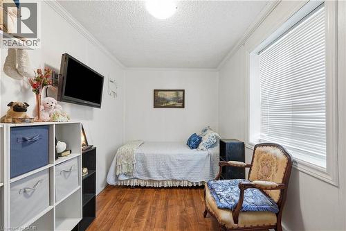 Bright room featuring wood-finish flooring, white walls, and crown molding - 153 Montrose Street N, Cambridge, ON - Indoor Photo Showing Bedroom