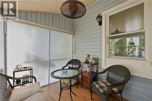 Covered porch featuring wood-finish flooring, light blue siding, and a single-hung window - 153 Montrose Street N, Cambridge, ON - 