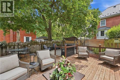 Expansive wood deck with dark wood railings and an integrated swing structure - 153 Montrose Street N, Cambridge, ON - Outdoor With Deck Patio Veranda With Exterior