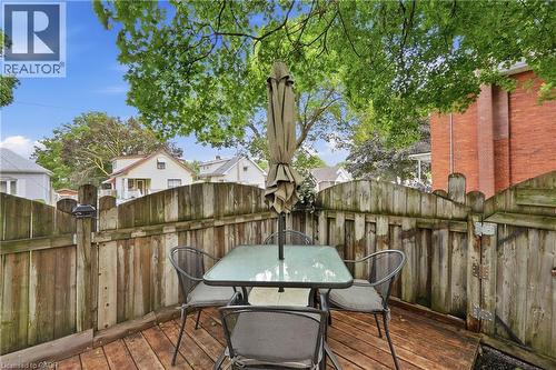 Wood-finish decking with a surrounding privacy fence and mature trees providing natural shade - 153 Montrose Street N, Cambridge, ON - Outdoor With Deck Patio Veranda With Exterior