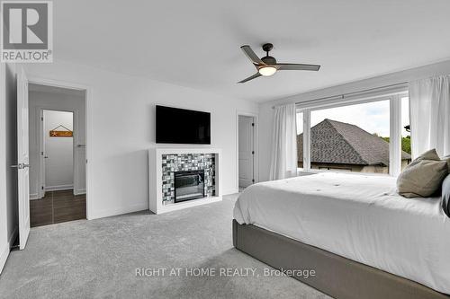 32 Edenbridge Court, Ottawa, ON - Indoor Photo Showing Bedroom With Fireplace
